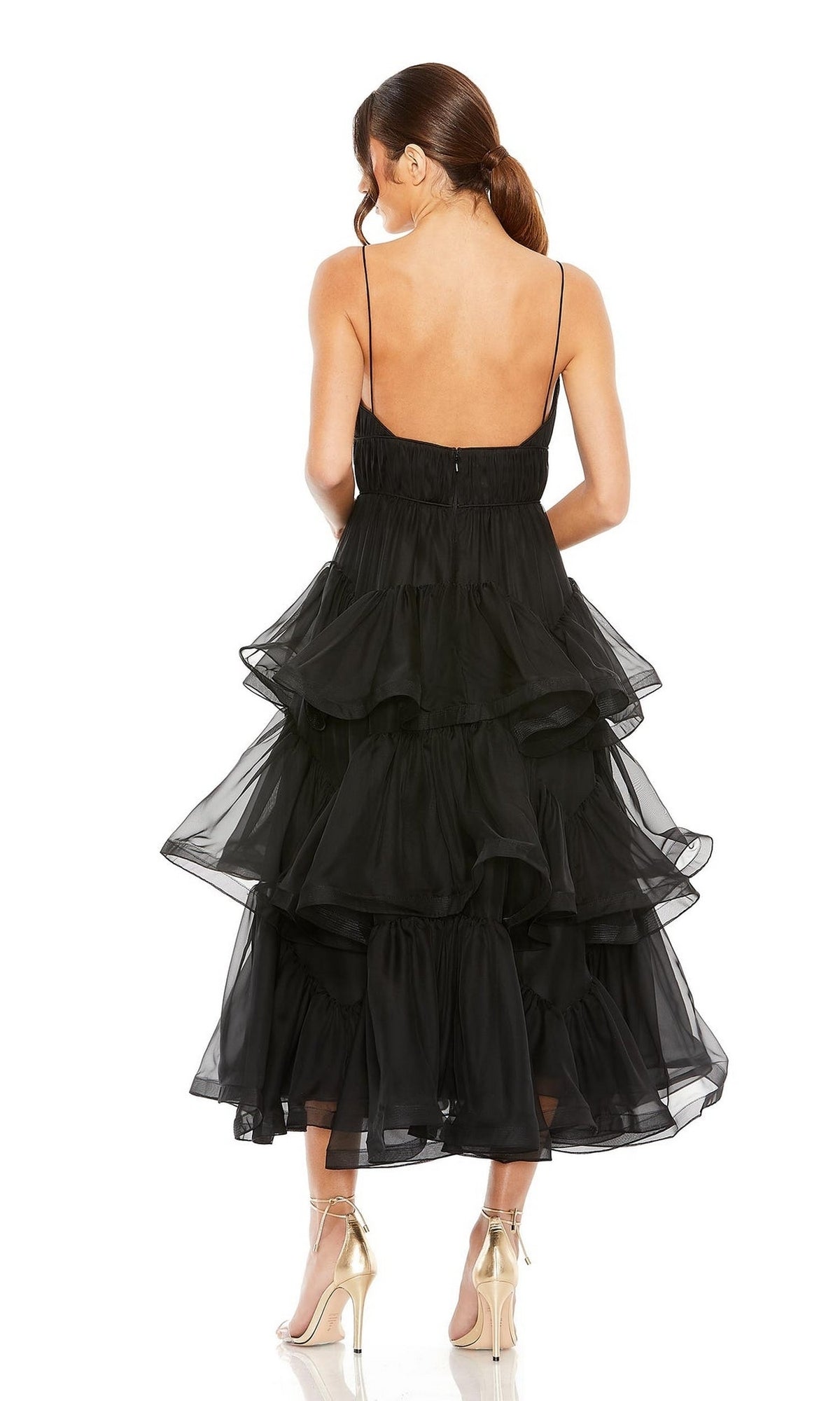 Woman wears the Mac Duggal 68411—an elegant tiered black midi dress with spaghetti straps and open back, paired with gold heels. Perfect as a Midi Black Wedding Guest Dress or chic party attire.